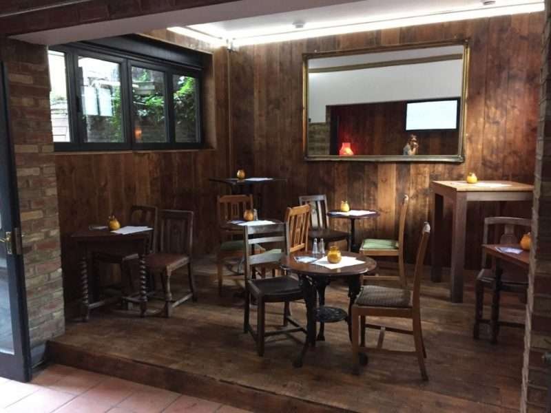 dining area with rustic flooring and furniture